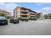 Condominium complex featuring multiple levels and ample parking on a sunny day at 9501 Shore Dr. # 135, Myrtle Beach, SC 29572