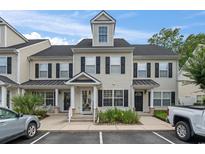 Inviting townhome with classic black shutters and covered front porch at 108 Barnacle Ln. # 4, Little River, SC 29566