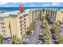 Beautiful oceanfront condo complex with lush landscaping, palm trees, and convenient parking at 139 S Dunes Dr. # 304, Pawleys Island, SC 29585