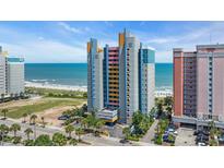 Bright, colorful condo building at the beach with ocean views and palm trees at 1700 N Ocean Blvd. # 651, Myrtle Beach, SC 29577
