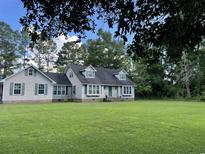 Charming one-story home featuring a well-manicured lawn and classic green shutters at 1872 Harris Short Cut Rd., Conway, SC 29526