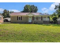 Charming single-story home with a well-manicured lawn and inviting front porch at 320 Edgewood Circle, Conway, SC 29527