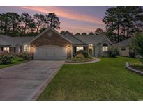 Charming single-story home with manicured lawn, brick accents, and attached two-car garage at 4726 Southern Trail, Myrtle Beach, SC 29579