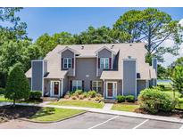 Charming townhome featuring gray siding, red shutters, and well-maintained landscaping at 503 20Th Ave. N # 9D, North Myrtle Beach, SC 29582