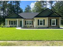 Charming single-story home showcasing a manicured lawn and inviting curb appeal at 5310 Pauley Swamp Rd., Conway, SC 29527