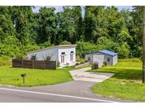 Modern home featuring a well-maintained lawn, an outbuilding and a stylish, minimalist design at 709 Highway 90, Conway, SC 29526