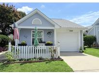 Charming single-story home with a white picket fence, inviting porch, and well-maintained lawn at 110 Cambridge Circle, Myrtle Beach, SC 29577