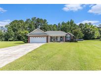 Charming single-story brick home boasts a two-car garage and well-manicured lawn at 1134 Carleita Circle, Conway, SC 29527