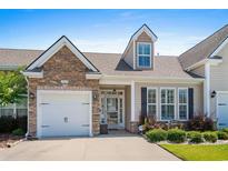 Charming single-Gathering home featuring a stone facade, attached garage, and well-manicured front yard at 156 Parmelee Dr. # D, Murrells Inlet, SC 29576