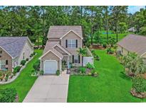 Well-maintained two-story home with attached garage, beautiful landscaping, and lush green lawn in a desirable neighborhood at 161 Barclay Dr., Myrtle Beach, SC 29579