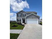 Charming two-story home with gray siding, black shutters, manicured lawn, and a two-car garage at 1715 Perthshire Loop, Myrtle Beach, SC 29579