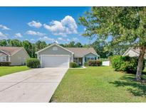 Charming single-story home with a well-manicured lawn and attached two-car garage at 219 Blackpepper Loop, Little River, SC 29566