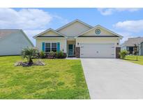 Charming single-story home with manicured lawn, attached two-car garage, and quaint curb appeal at 227 Palm Terrace Loop, Conway, SC 29526