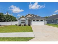 Charming home with a two-car garage, well-manicured lawn, and inviting curb appeal at 2599 Woodcreek Ln., Conway, SC 29527