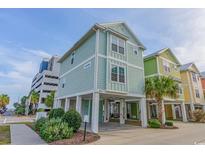 Bright and inviting beach home with a lovely exterior and coastal charm, raised on stilts near the beach at 2701 Kashton Dr., Myrtle Beach, SC 29577