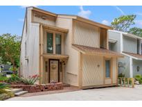 Charming two-story townhouse featuring a unique design, well-maintained landscaping, and inviting front entrance at 310 74Th Ave. N # 7, Myrtle Beach, SC 29572