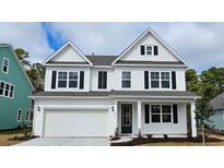 Charming two-story home with white siding, black shutters, and an attached two-car garage at 383 Wingspan Ct., Myrtle Beach, SC 29588