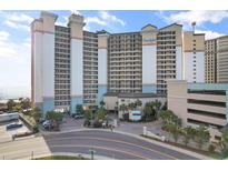 A large condo with palm trees, covered parking and sign saying Beach Cove Resort at 4800 Ocean Blvd. S # 1119, North Myrtle Beach, SC 29582