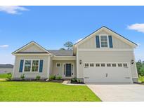 Charming single-Gathering home featuring a two-car garage, craftsman-style design and a well-maintained front lawn at 5009 Shore Breeze Dr., Myrtle Beach, SC 29588