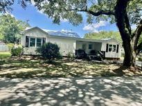 Charming single-story home with white siding, black shutters and a well-manicured front yard at 518 Nowell St., Georgetown, SC 29440