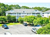 A charming two-story condo building with inviting balconies and verdant landscaping at 5825 Catalina Dr. # 833, North Myrtle Beach, SC 29582