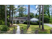 Beautiful one story home featuring a large front yard, mature trees and charming curb appeal at 59 Bay Tree Ln., Pawleys Island, SC 29585
