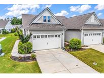 Charming home exterior features a two-car garage with a spacious driveway and well manicured landscaping at 6029 Campanella St., Myrtle Beach, SC 29572