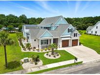 Stunning, professionally landscaped home with three-car garage, and well-manicured lawn at 607 Boone Hall Dr., Myrtle Beach, SC 29579