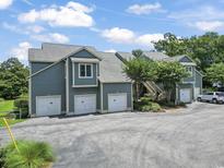 Charming townhomes with private garages, stairs to entrances, and lush landscaping at 824 Castleford Circle # 7C, Myrtle Beach, SC 29572