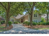 Charming home featuring a lush, mature landscape and a welcoming front entrance at 907 Tidewater Dr., North Myrtle Beach, SC 29582