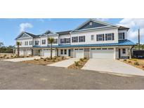 New townhome row features a neutral color scheme, personal driveway, and attached garage at Tbb Lineback Pl. # 32, Longs, SC 29568