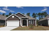 Charming brown house featuring a white garage door, complemented by well-maintained landscaping at 1239 Maxwell Dr., Little River, SC 29566