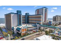 Stunning coastal resort with multiple buildings, pedestrian bridge, ocean views, and outdoor pool amenities at 1501 S Ocean Blvd. # 1039, Myrtle Beach, SC 29577