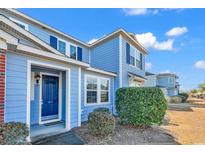 Charming two-story blue townhome featuring well-maintained landscaping and a welcoming entrance at 1857 Culbertson Ave. # 1857, Myrtle Beach, SC 29577