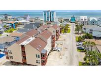 Lovely aerial view showcasing a building complex with patios, and an ocean view in the background at 212 29Th Ave. N # 204, North Myrtle Beach, SC 29582