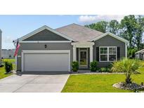 Charming one-story home with manicured lawn, attached garage, and inviting curb appeal at 305 Forestbrook Cove Circle, Myrtle Beach, SC 29588