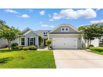 Charming single-story home featuring a well-manicured lawn and an attached two-car garage at 3647 Diamond Stars Way, Little River, SC 29566