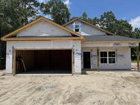 An exterior view of a house under construction with an attached two-car garage at 4032 Copperhead Rd., Conway, SC 29527