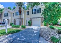 Charming townhome with stone accents, attached garage, well-kept lawn and mature trees at 4355 Rivergate Ln. # F, Little River, SC 29566