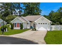 Charming single-story home featuring a manicured lawn and attached garage with a paved driveway at 483 Oakmont Dr., Myrtle Beach, SC 29579