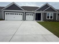 Charming home with a large driveway leading to a three-car garage at 528 Oak Landing Dr., Myrtle Beach, SC 29588