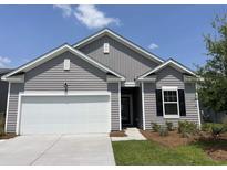 Charming single-story home with gray siding, white trim, and an attached two-car garage with manicured front lawn at 606 Muster Field Ct., Conway, SC 29526