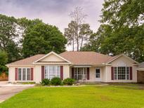 Charming single-story home with well-maintained lawn and attractive landscaping at 6936 Woodhaven Dr., Myrtle Beach, SC 29588