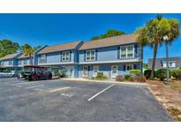 Charming two-story condo with a parking area and vibrant blue exterior at 832 Villa Dr. # 832, North Myrtle Beach, SC 29582