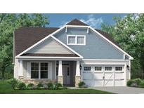 Charming home showcasing a mix of stone, clapboard and shingle siding, and a two-car garage at 1196 Halter Pl., Calabash, NC 28467