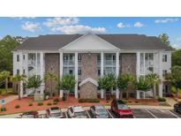 Charming condo building with a manicured landscape, providing an inviting curb appeal at 124 Birch N Coppice Dr. # 1, Surfside Beach, SC 29575
