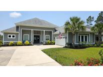 Stunning single-story home with a well-manicured lawn and an attached two-car garage at 1455 Whooping Crane Dr., Conway, SC 29526