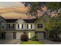 Charming townhouses with manicured lawns, brick accents, and warm exterior lighting at sunset at 2131 Cass Lake Dr. # 662, Carolina Shores, NC 28467