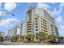 An attractive shot of the building, with palm trees in the foreground and blue sky in the background at 2501 S Ocean Blvd. # 503, Myrtle Beach, SC 29577