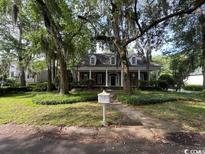 Charming traditional home with mature trees and lush landscaping, including a mailbox at 274 Widgeon Dr., Pawleys Island, SC 29585